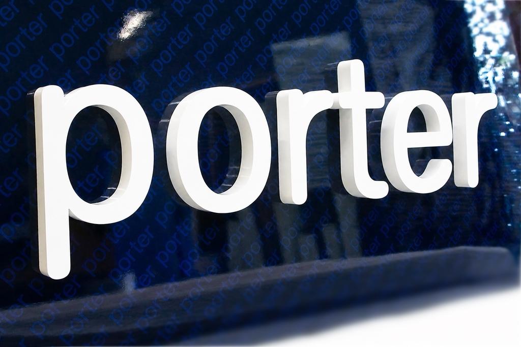 Close-up of white dimensional Porter letters on a reflective blue panel