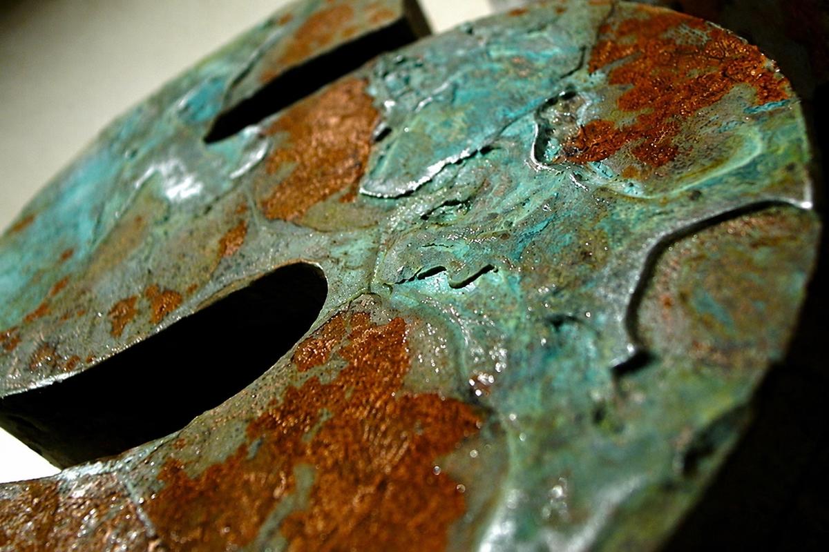 Macro view of turquoise verdigris and rust texture on a high-density sign foam letter at the ROM in Toronto.