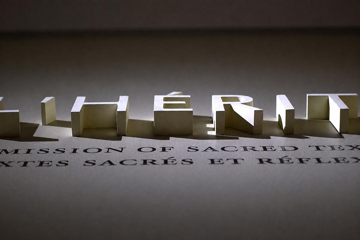 Low-angle view of cream foam lettering and cast shadows at the Dead Sea Scrolls exhibition, ROM Toronto.