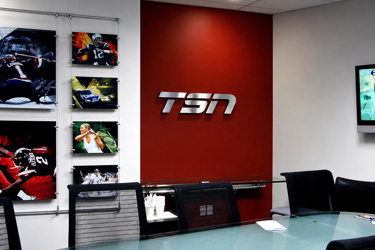 TSN Canada boardroom with a dimensional silver logo installed on a red feature wall.