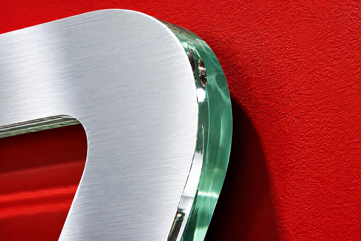 Polished edge detail of a ¾-inch green-edge acrylic TSN corporate logo.