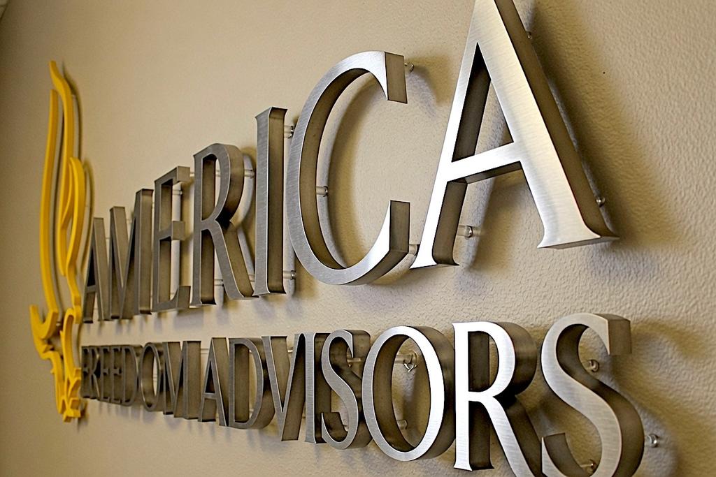 Close-up of America Freedom Advisors brushed nickel wall letters on ½-inch spacers