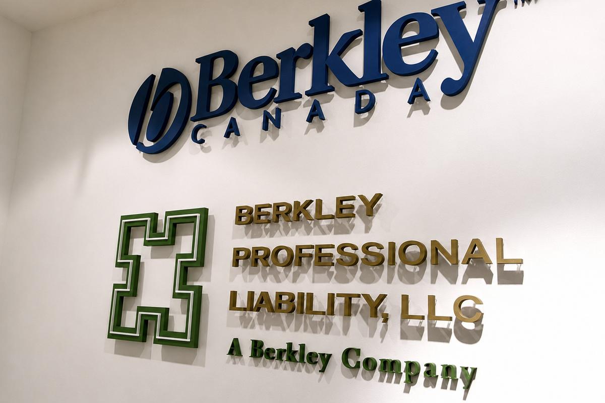 Angled view of blue Berkley Canada lettering and green and gold dimensional acrylic wall signs