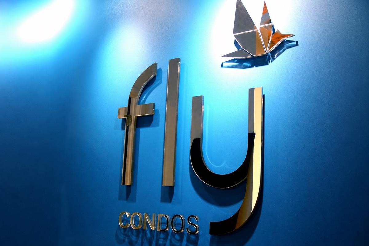 Close-up of FLY Condos mirror acrylic letters and water-clear edges