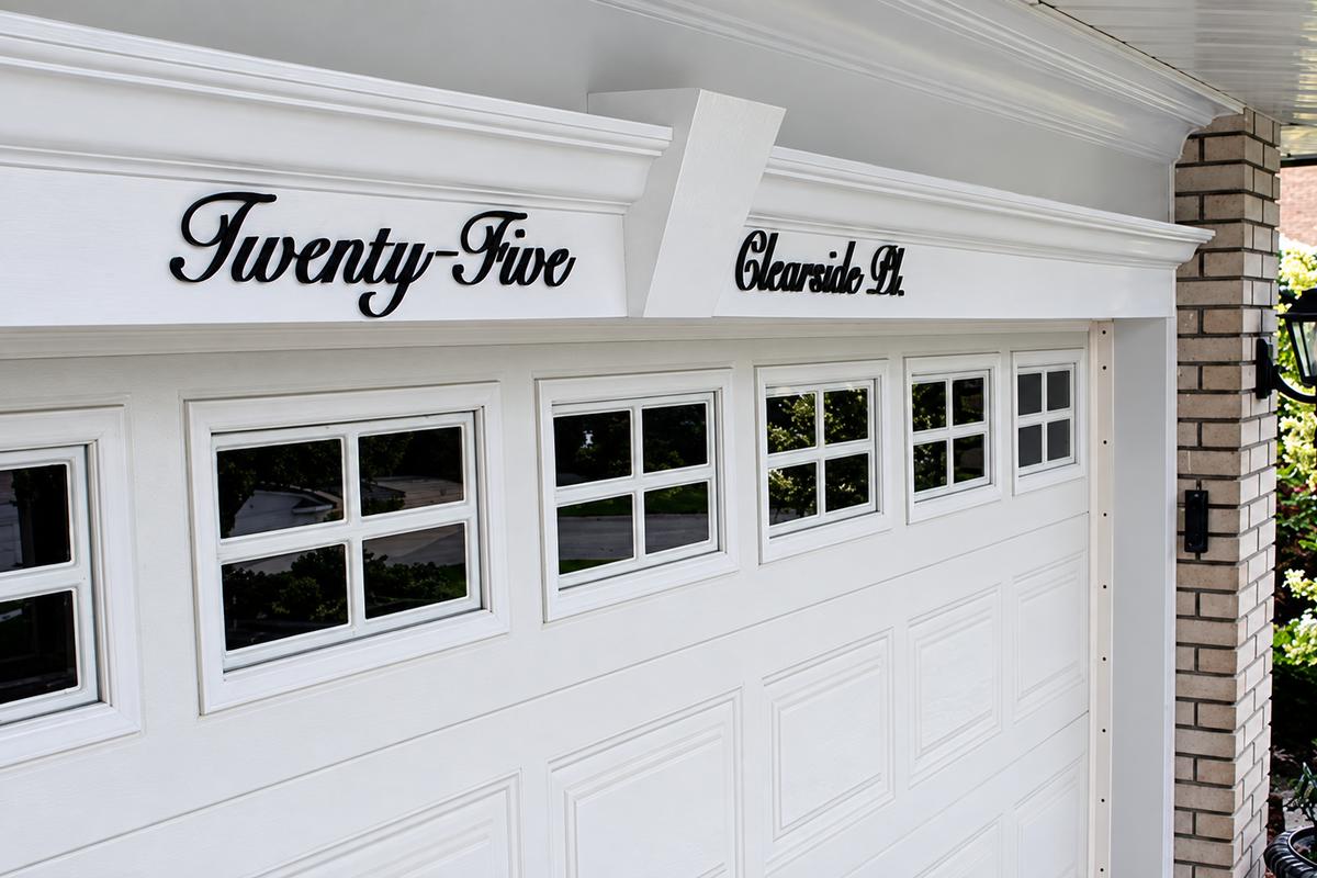 Black acrylic Twenty-Five and Clearside Pl. address scripts on a white garage fascia