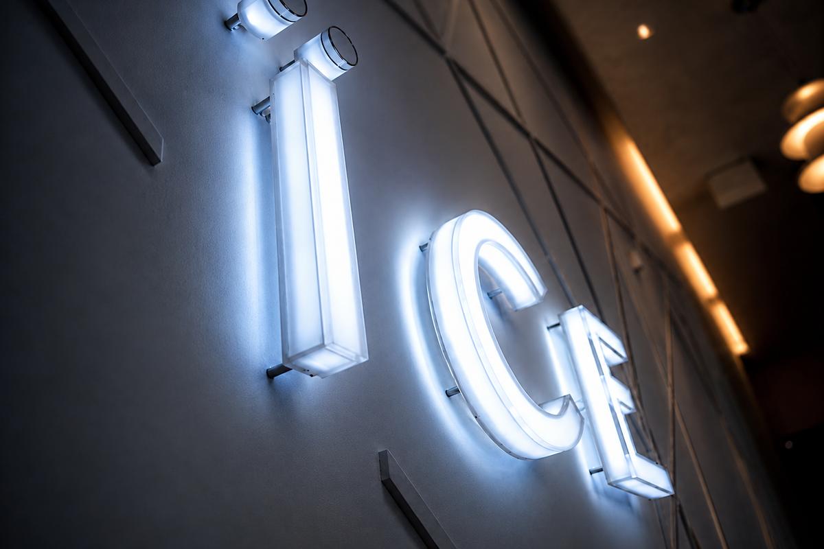 Dramatic low-angle view of the ICE Condominiums sales centre sign with internally LED-illuminated 2-inch-deep letters and glowing returns.