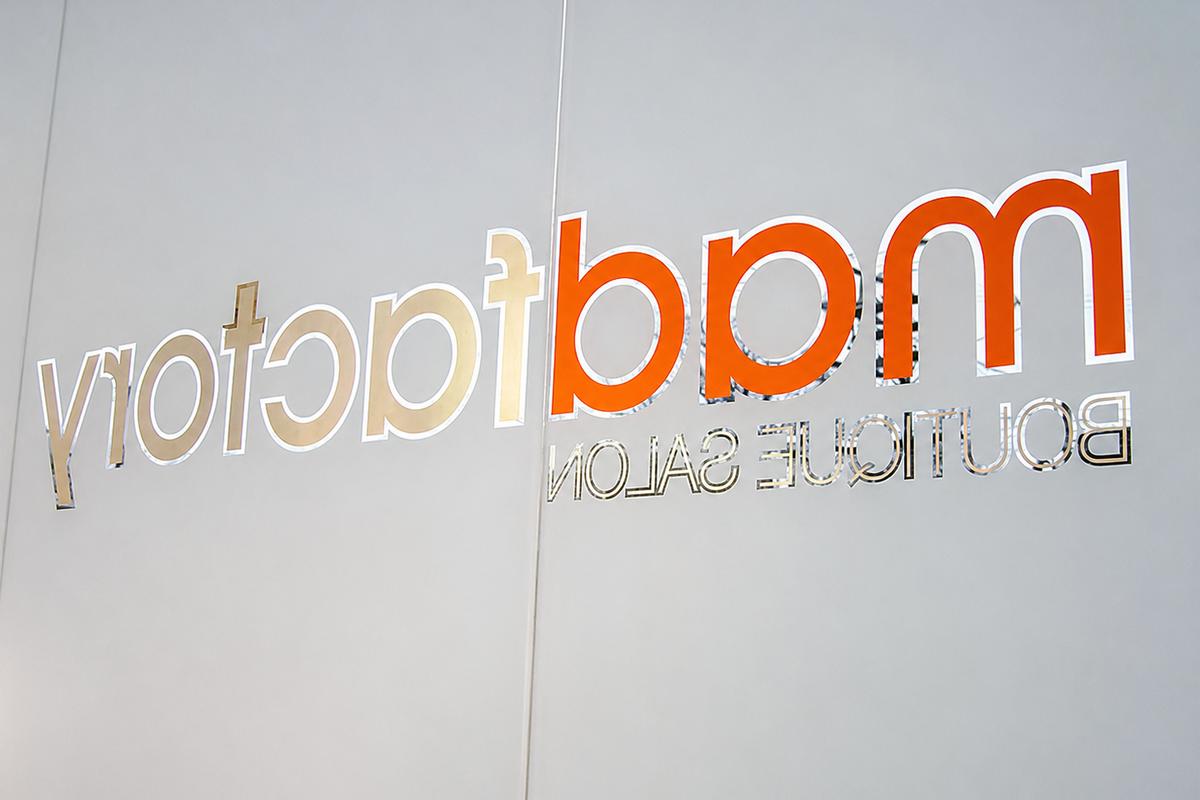 Madfactory window logo viewed from inside the Toronto salon