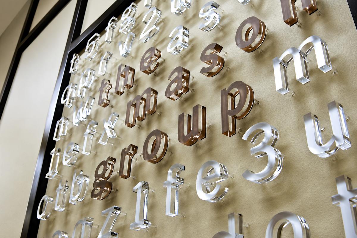 Close up of raised acrylic lobby signage on reception area wall in corporate business office