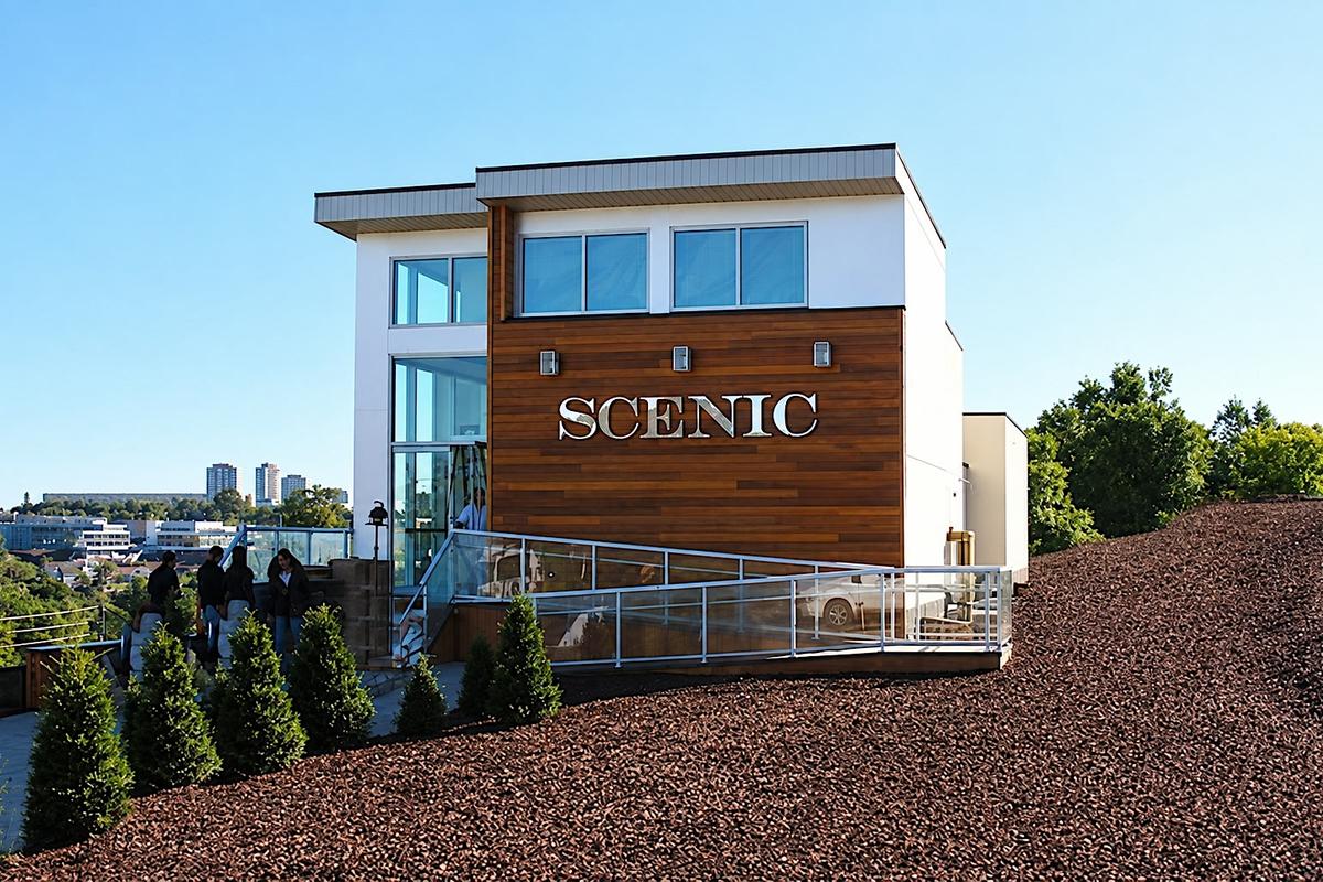 SCENIC eight-foot dimensional logo, 3/4-inch clear acrylic laminated with 1/4-inch second-surface mirror acrylic, threaded-rod mount on horizontal wood cladding, Toronto sales office exterior
