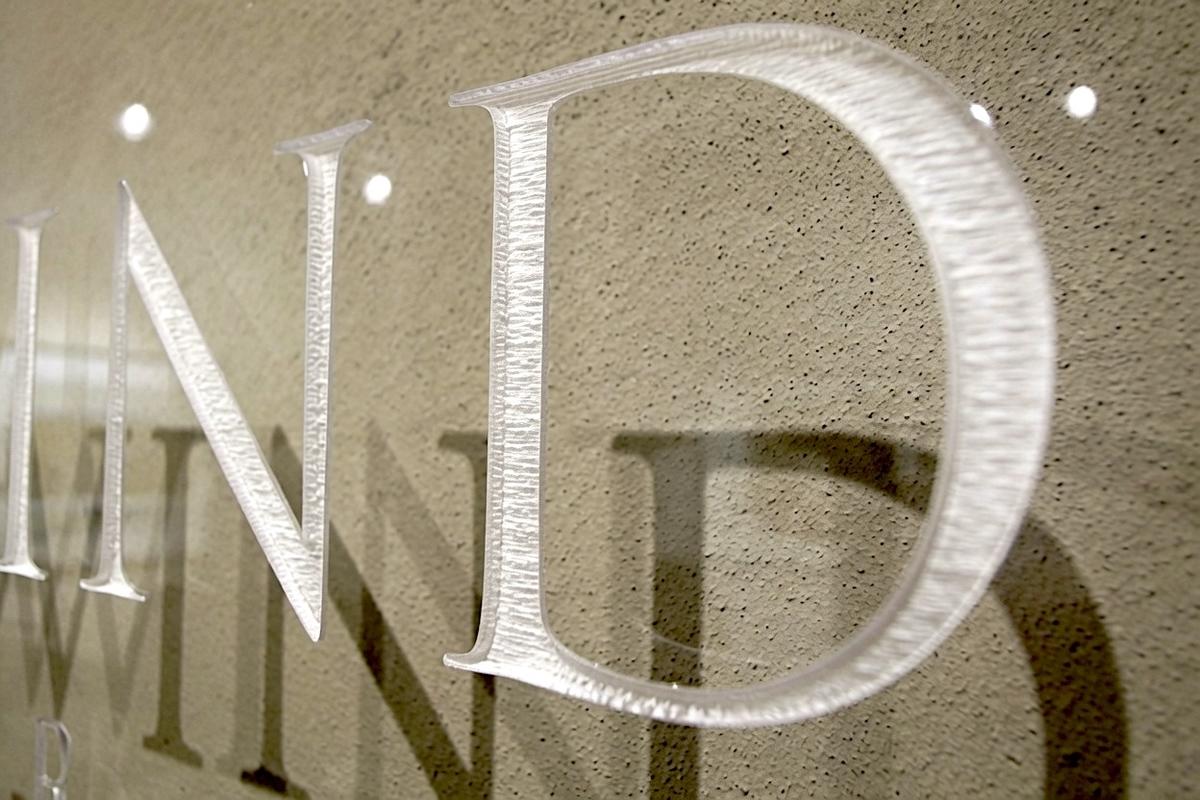 Close-up of raster-engraved Westwind lettering and shadows on clear acrylic